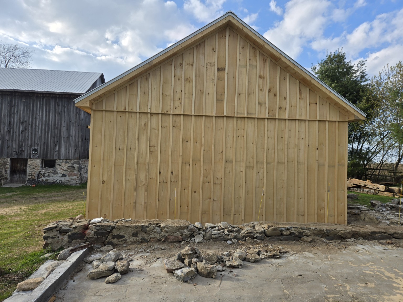 Gable elevation of the Scugog barn with vertical wood siding