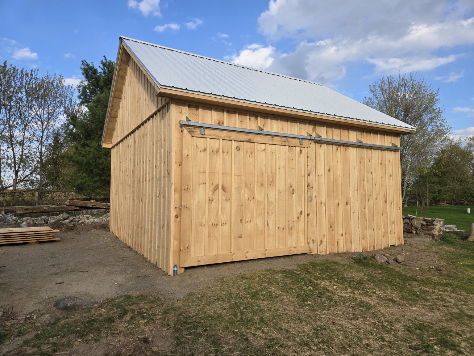 Completed Scugog timber-frame barn with its wide sliding door