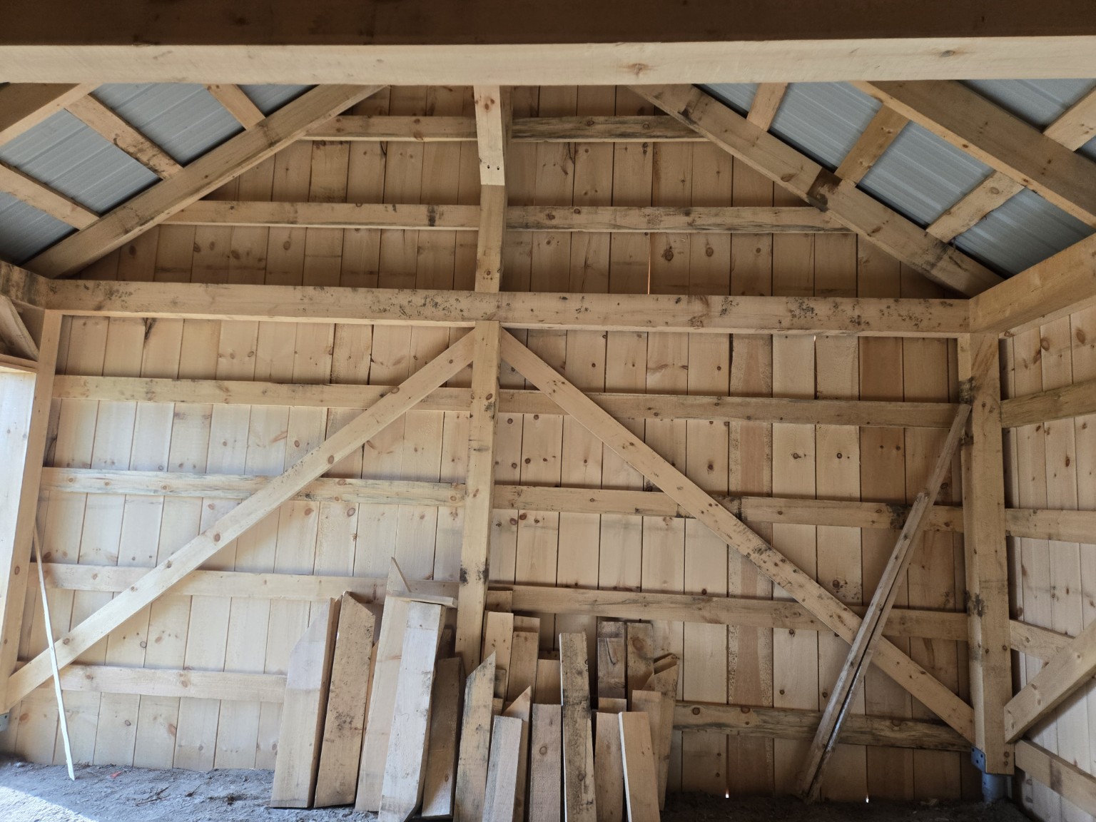Timber-frame gable and bracing inside the Scugog barn