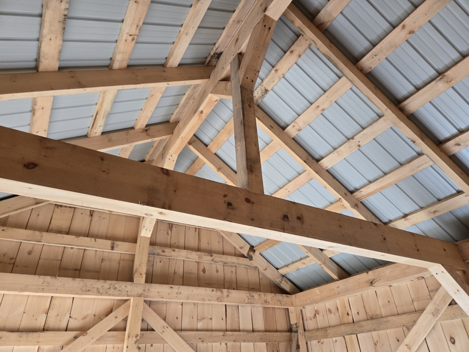 Exposed timber-frame roof structure inside the completed Scugog barn