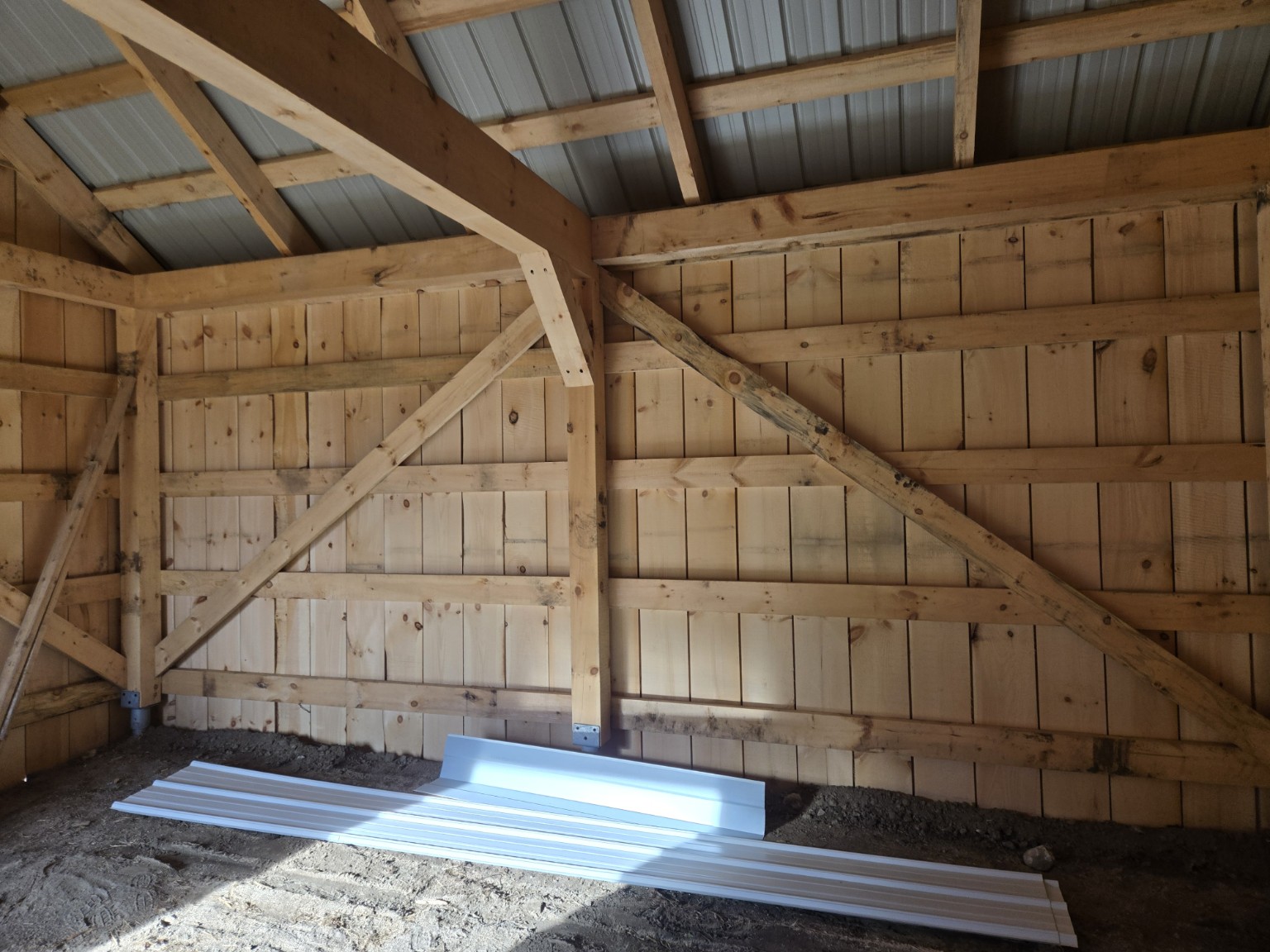 Interior timber wall framing and board cladding in the Scugog barn